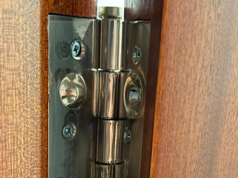Bisagra de seguridad en una puerta de madera